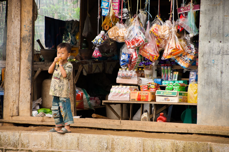 “Small Lao Boy outside a Shop” by Emma Jones