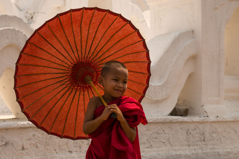 “Smiling Monk under an Umbrella” by Emma Jones